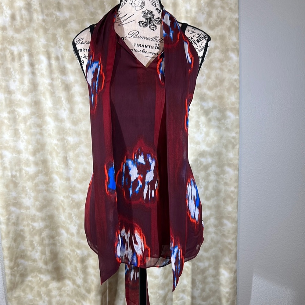 Get the “ Scoop” on this cute fashionable sleeveless blouse!!! Two tone Red.